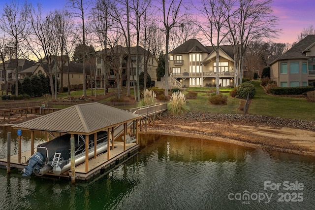 view of dock featuring a yard and a water view