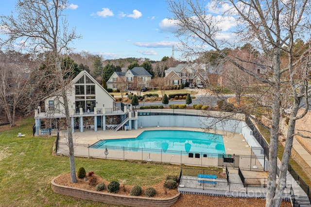 view of swimming pool featuring a patio and a yard