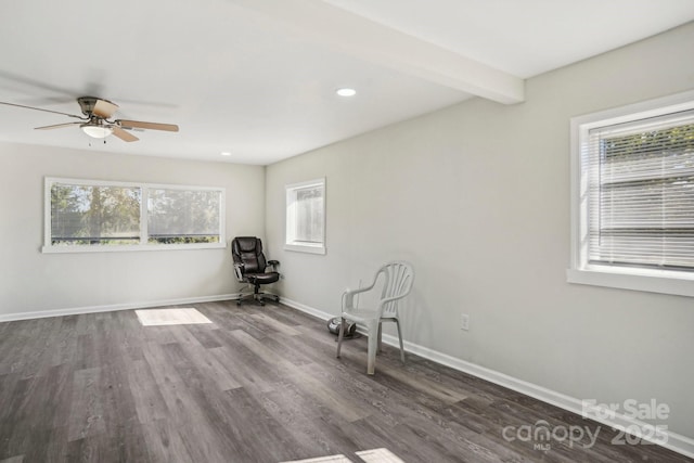 unfurnished room featuring ceiling fan, dark hardwood / wood-style floors, and beamed ceiling