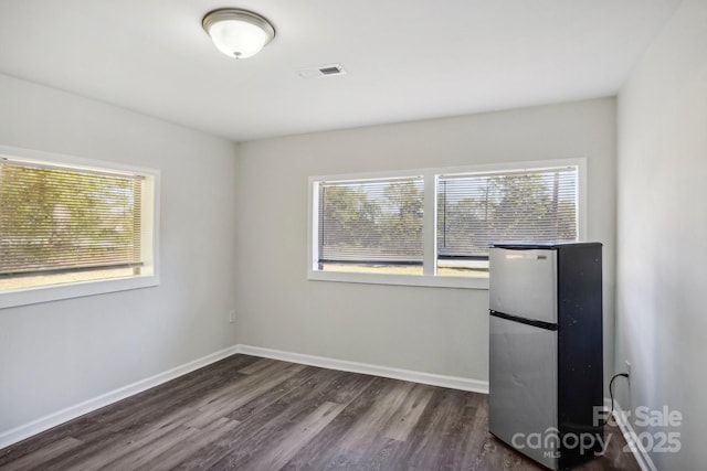 spare room with dark wood-type flooring