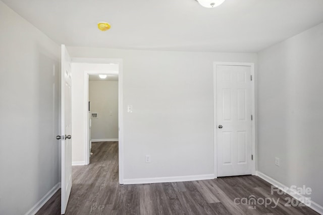 empty room featuring dark wood-type flooring