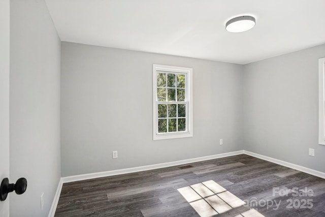 unfurnished room with dark hardwood / wood-style flooring