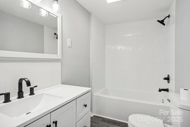 full bathroom with shower / tub combination, vanity, toilet, and wood-type flooring