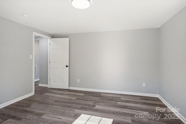 spare room featuring dark hardwood / wood-style floors