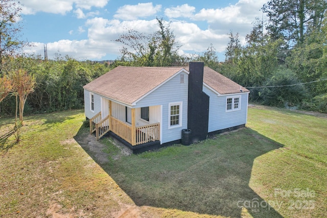 view of side of home with cooling unit and a yard