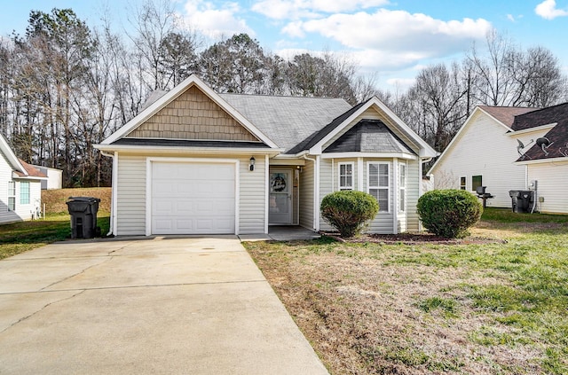 view of front of property with a garage and a front lawn