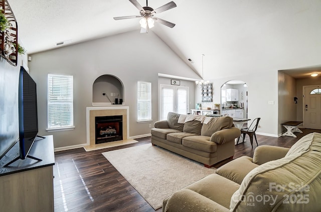 living room with ceiling fan, dark hardwood / wood-style floors, and high vaulted ceiling