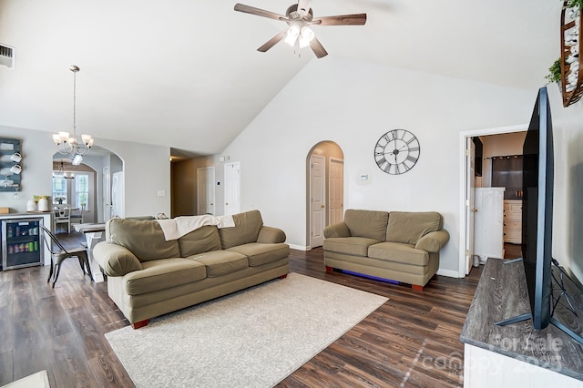 living room with dark hardwood / wood-style floors, ceiling fan with notable chandelier, high vaulted ceiling, and beverage cooler