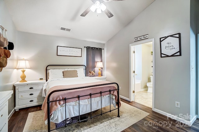 bedroom with dark wood-type flooring, ensuite bath, lofted ceiling, and ceiling fan