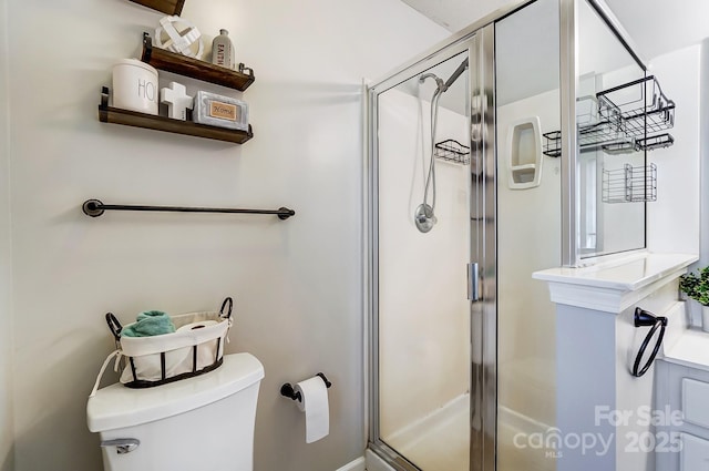 bathroom with a shower with door and toilet