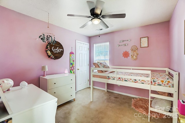 bedroom with light colored carpet, ceiling fan, and a closet