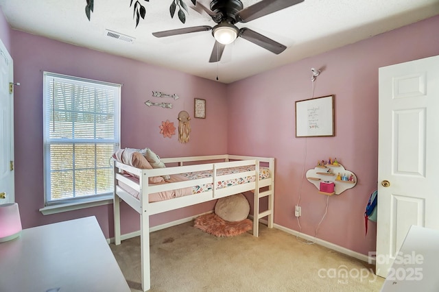 bedroom featuring ceiling fan and light carpet