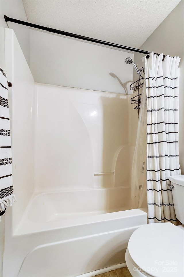 bathroom with shower / tub combo with curtain, tile patterned flooring, toilet, and a textured ceiling