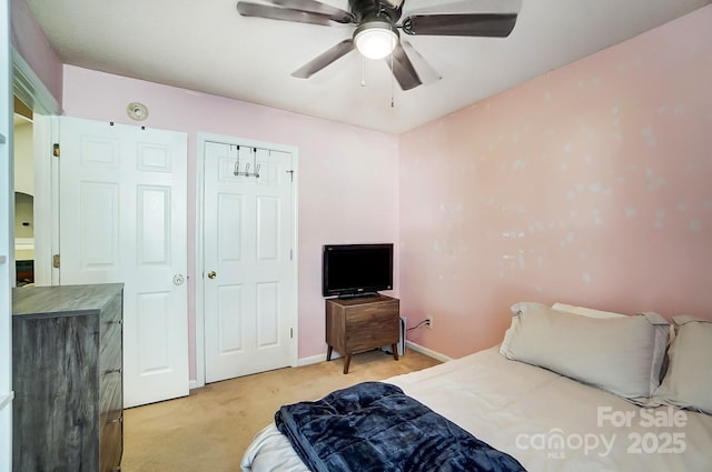 bedroom featuring light colored carpet and ceiling fan