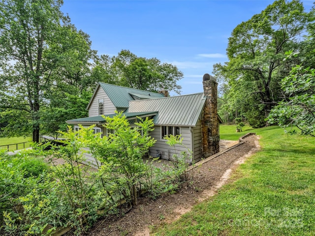 view of side of home featuring a yard