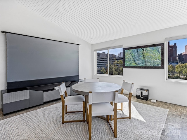 dining space featuring vaulted ceiling