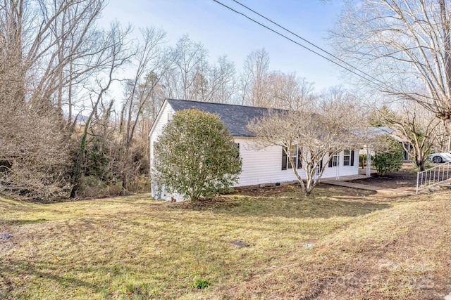 view of side of property with a yard