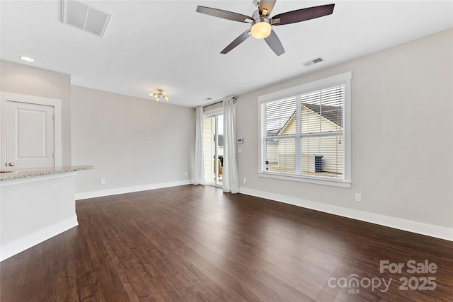 unfurnished living room featuring dark hardwood / wood-style floors and ceiling fan