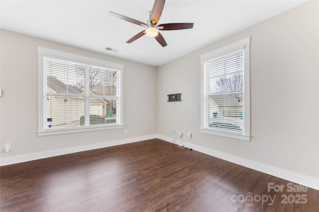 empty room with dark hardwood / wood-style floors and ceiling fan