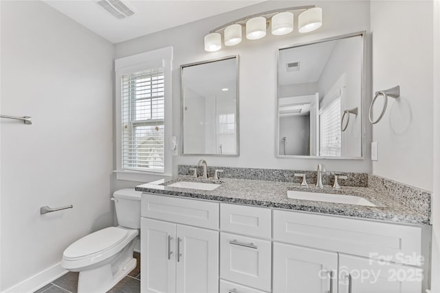 bathroom featuring vanity and toilet