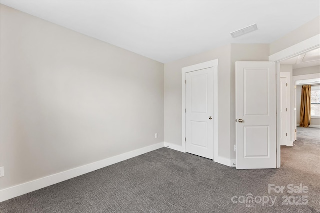 unfurnished bedroom featuring dark colored carpet