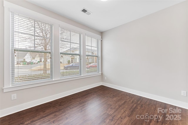 spare room with dark hardwood / wood-style flooring