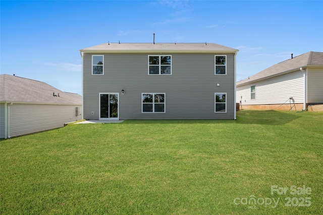 rear view of house with a yard