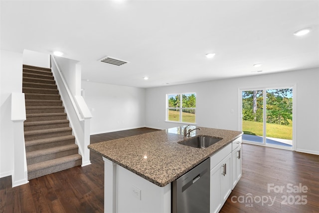 kitchen featuring stone counters, dishwasher, sink, and white cabinets