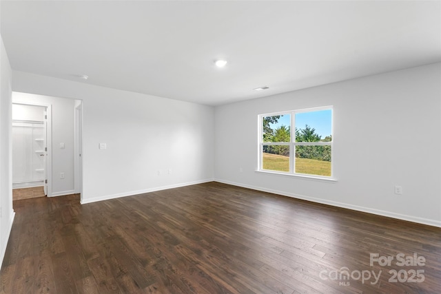 empty room featuring dark hardwood / wood-style flooring