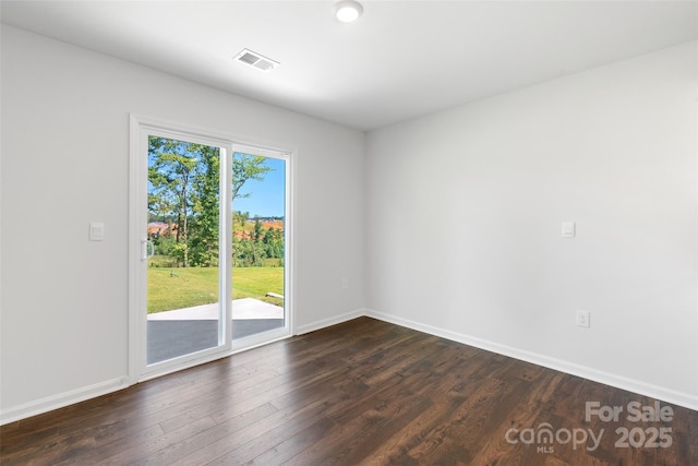 empty room with dark wood-type flooring