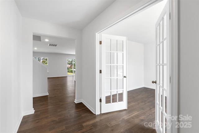 hall featuring dark wood-type flooring and french doors