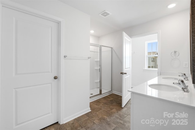 bathroom featuring vanity and a shower with shower door