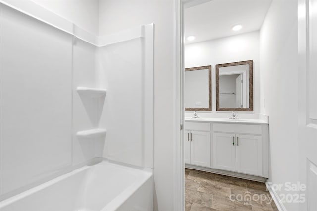 bathroom featuring vanity and bathing tub / shower combination