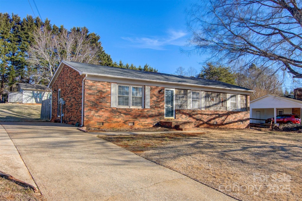 single story home with a carport and a garage