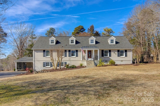 cape cod house with a front yard and a carport