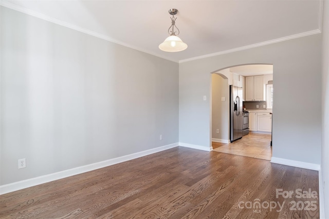 unfurnished room featuring crown molding and light hardwood / wood-style floors