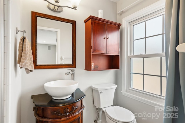 bathroom with vanity, plenty of natural light, and toilet