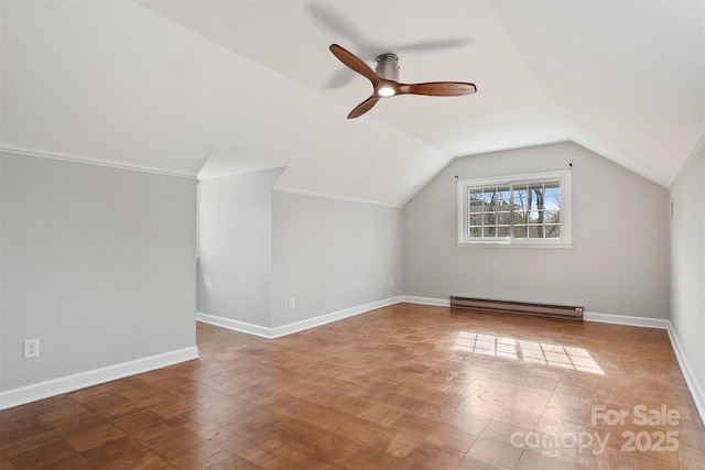 additional living space featuring ceiling fan, a baseboard radiator, and lofted ceiling