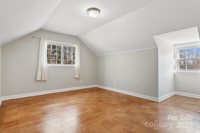 bonus room featuring a wealth of natural light and vaulted ceiling