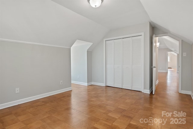 additional living space featuring light parquet flooring and lofted ceiling