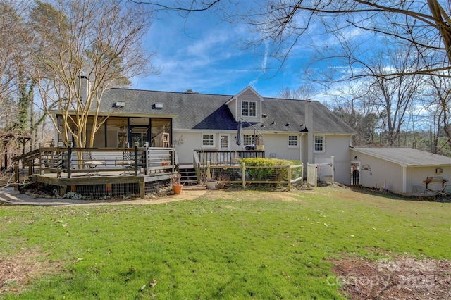 back of house with a wooden deck, a sunroom, and a yard