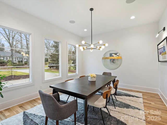 dining room with a chandelier and light wood-type flooring