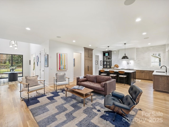 living room featuring sink and light wood-type flooring