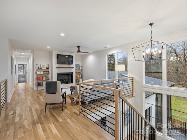 living room with ceiling fan and light wood-type flooring