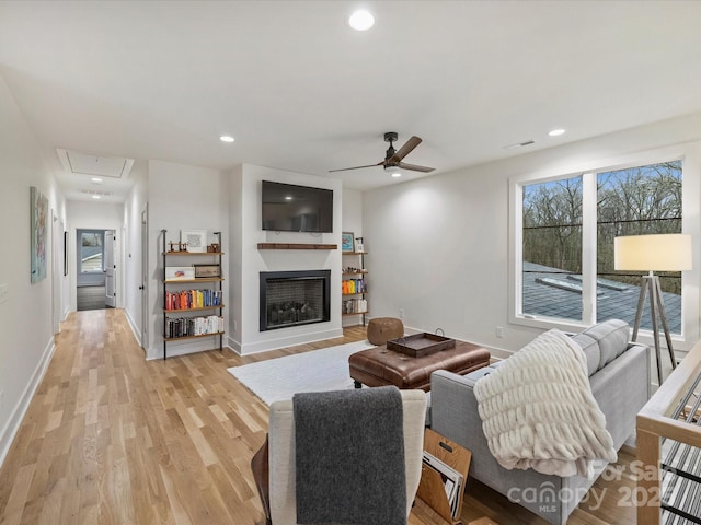 living room with ceiling fan and light hardwood / wood-style floors