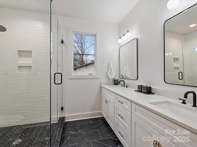 bathroom with vanity and a shower with shower door