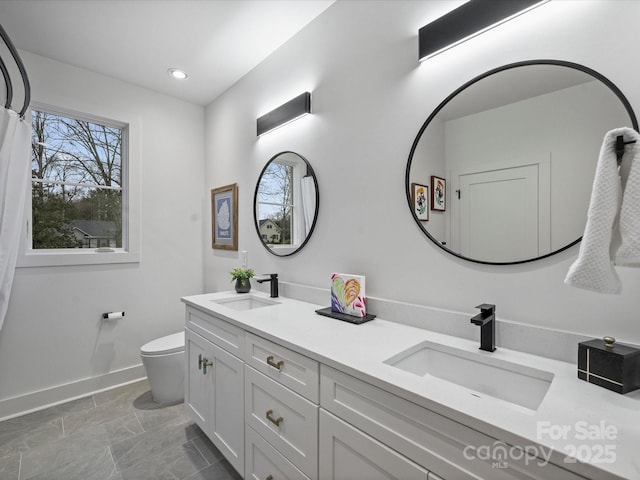 bathroom with vanity and toilet