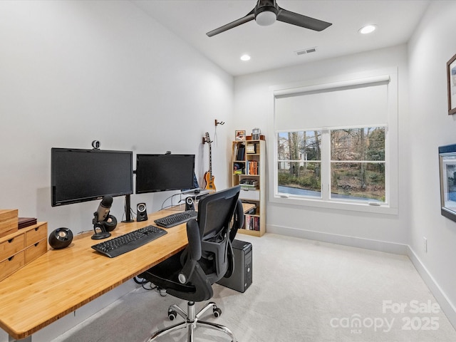 carpeted office featuring ceiling fan