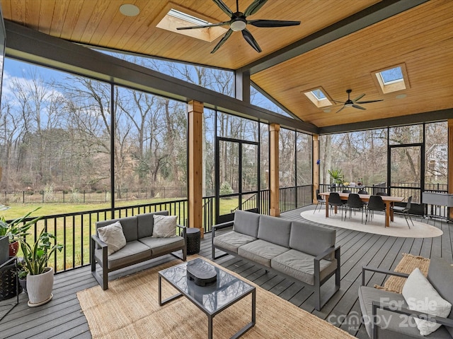 sunroom with plenty of natural light, wooden ceiling, and ceiling fan