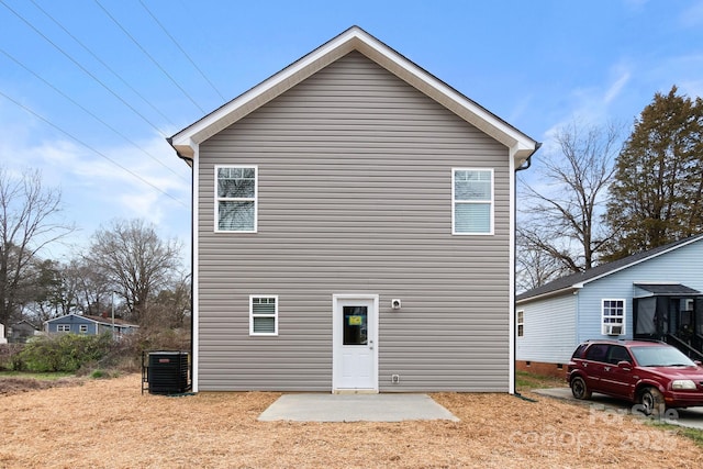 rear view of property with central AC and a patio